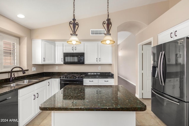 kitchen featuring sink, decorative light fixtures, black appliances, and a kitchen island