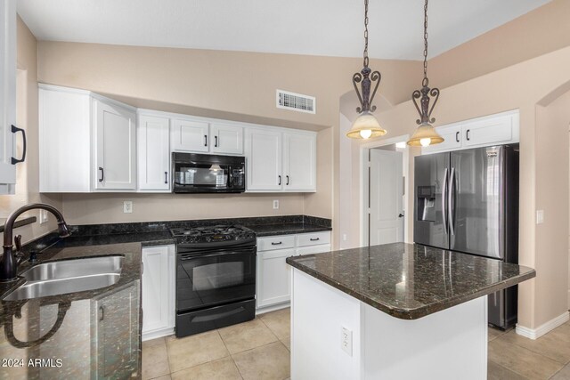 kitchen featuring lofted ceiling, dark stone countertops, white cabinets, black appliances, and sink