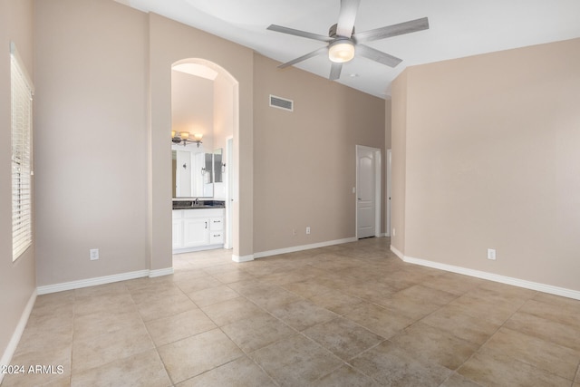 tiled empty room with ceiling fan