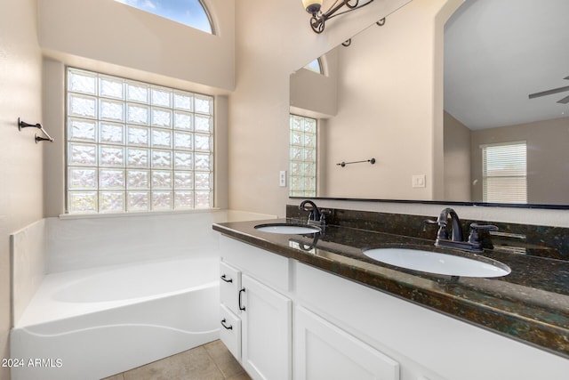 bathroom featuring tile patterned flooring, vanity, and a bathtub