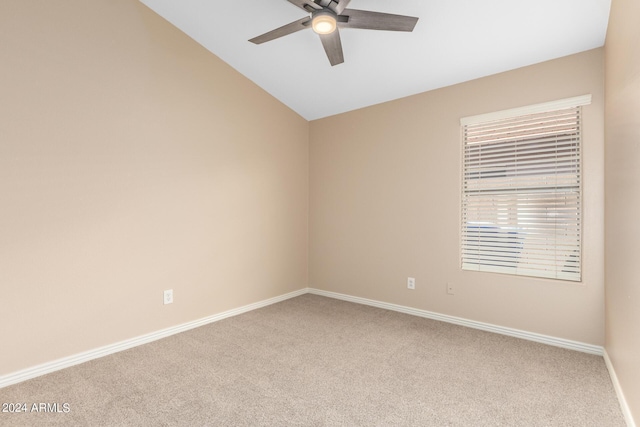 carpeted spare room with vaulted ceiling and ceiling fan