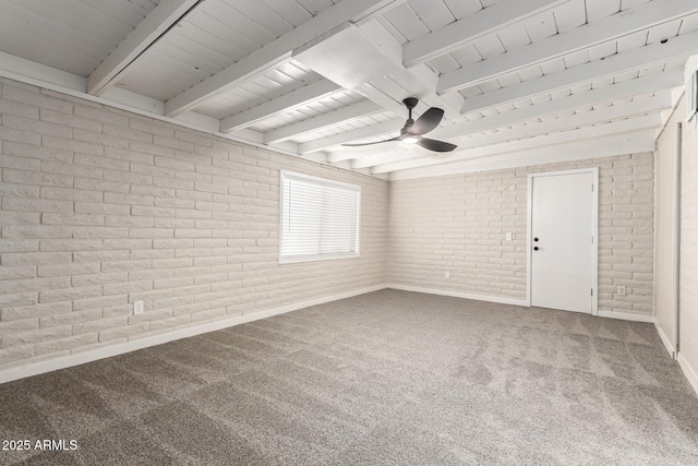 empty room with ceiling fan, beam ceiling, brick wall, and carpet flooring