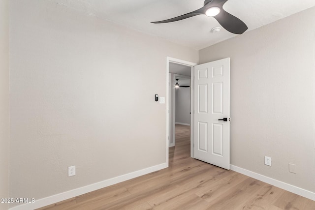 empty room featuring ceiling fan and light hardwood / wood-style floors