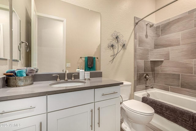 bathroom with a textured wall,  shower combination, vanity, and toilet