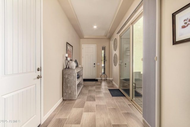 doorway to outside featuring baseboards