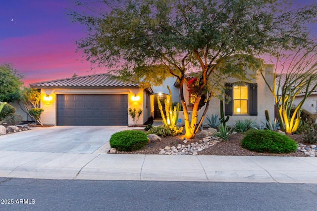 mediterranean / spanish-style house with a garage