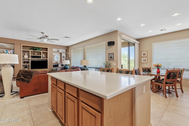 40128 N Integrity Trl, Anthem, AZ 85086 - kitchen with light tile patterned flooring, light countertops, ceiling fan, built in features, and recessed lighting
