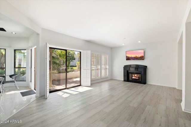 unfurnished living room with light wood-type flooring