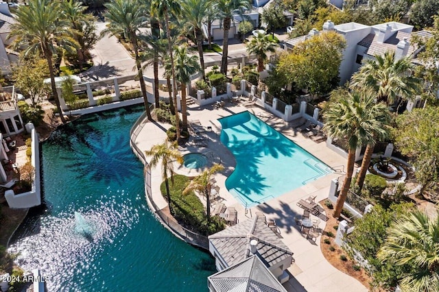 view of swimming pool with a patio and a water view