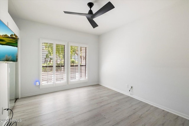 spare room featuring light wood-type flooring and ceiling fan