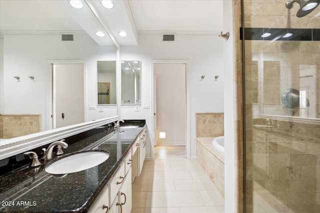 bathroom featuring plus walk in shower, vanity, tile patterned floors, and crown molding