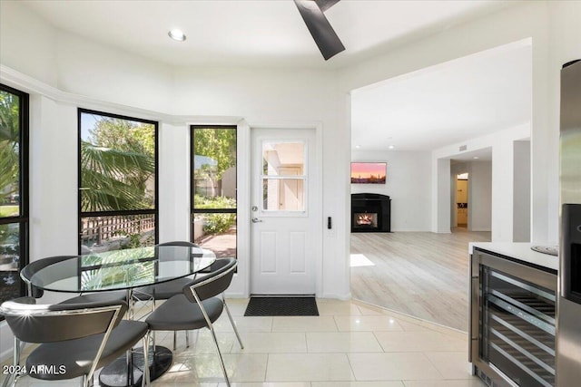 interior space featuring light hardwood / wood-style flooring, beverage cooler, and ceiling fan