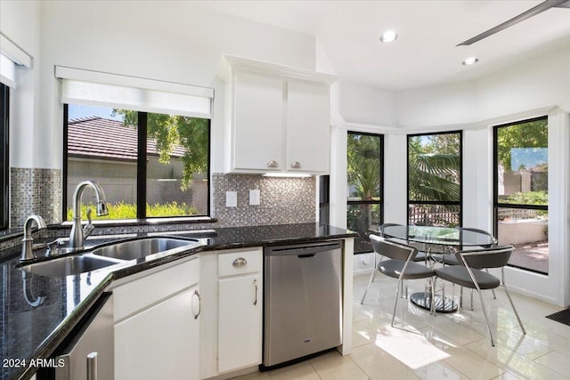 kitchen with white cabinetry, stainless steel dishwasher, plenty of natural light, and sink