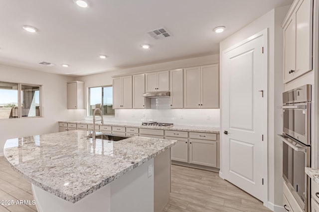 8553 N 175th Ln, Waddell, AZ 85355 - kitchen with a sink, appliances with stainless steel finishes, light stone countertops, tasteful backsplash, and recessed lighting