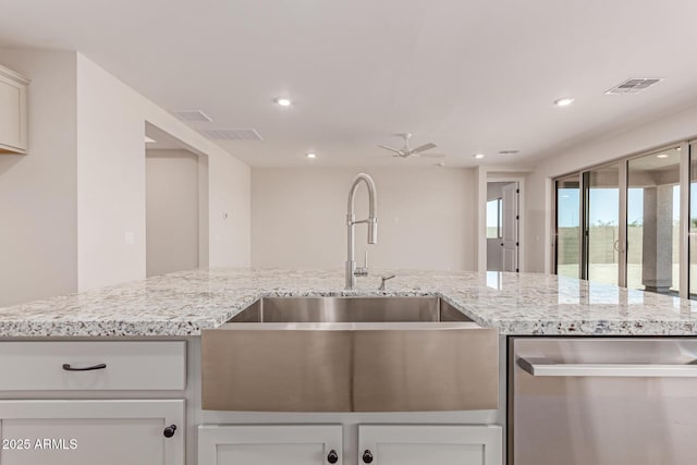 8553 N 175th Ln, Waddell, AZ 85355 - kitchen with dishwasher, a sink, ceiling fan, recessed lighting, and light stone countertops