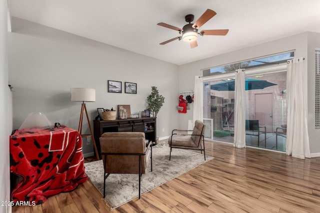 living area featuring ceiling fan and wood-type flooring