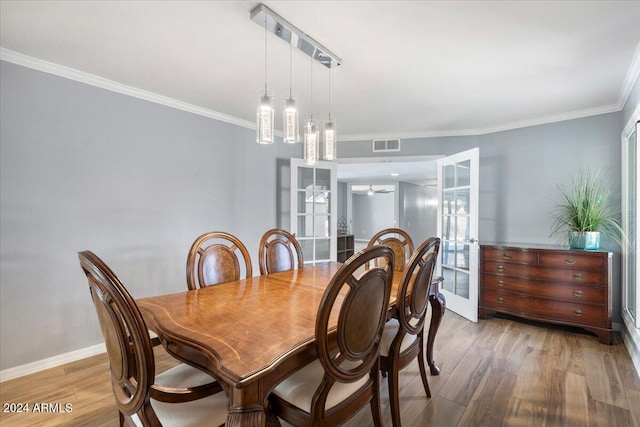 dining room with hardwood / wood-style floors, crown molding, french doors, and ceiling fan