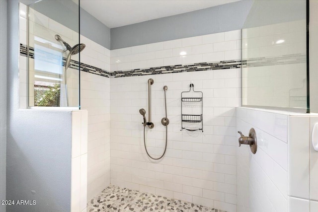 bathroom with tiled shower