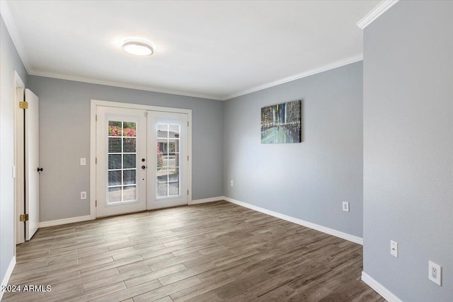 unfurnished room featuring french doors, light hardwood / wood-style floors, and ornamental molding