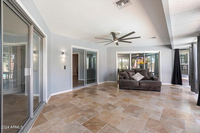 interior space with ceiling fan