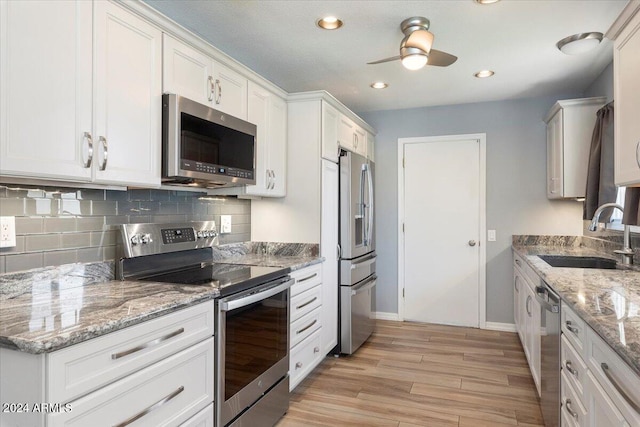 kitchen featuring white cabinets, stainless steel appliances, and sink