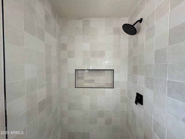 bathroom with tiled shower