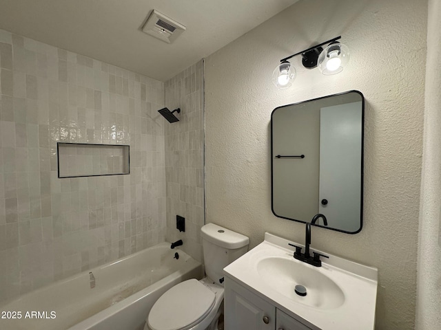 full bathroom featuring vanity, toilet, and tiled shower / bath