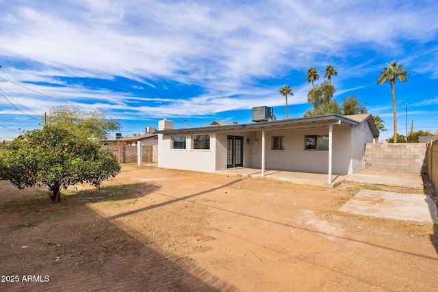 rear view of house with cooling unit and a patio