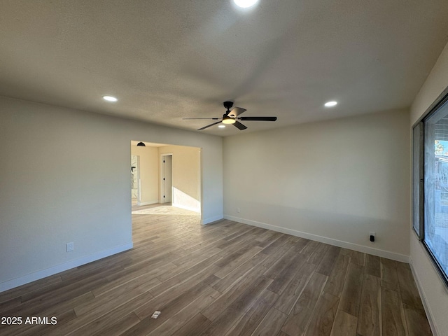 spare room with ceiling fan, hardwood / wood-style flooring, and a textured ceiling