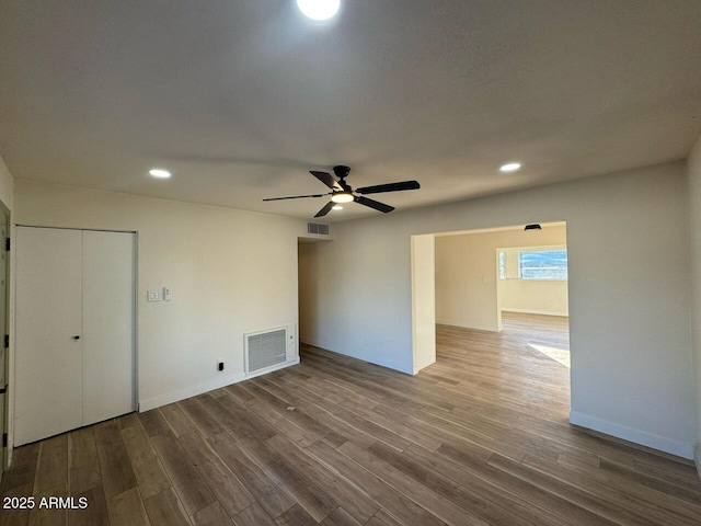 empty room featuring hardwood / wood-style floors and ceiling fan