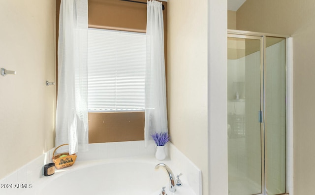 bathroom featuring separate shower and tub