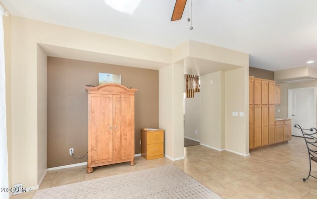 tiled empty room with ceiling fan