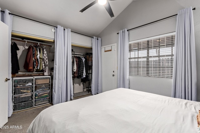 bedroom with lofted ceiling, carpet, a ceiling fan, and two closets