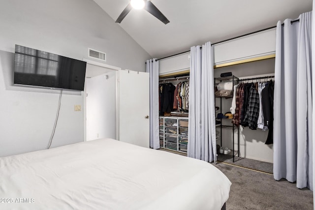 bedroom featuring lofted ceiling, ceiling fan, visible vents, multiple closets, and carpet