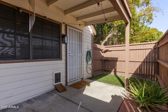 doorway to property with a patio and fence