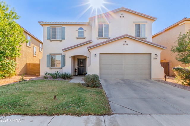 mediterranean / spanish-style home featuring a garage and a front lawn