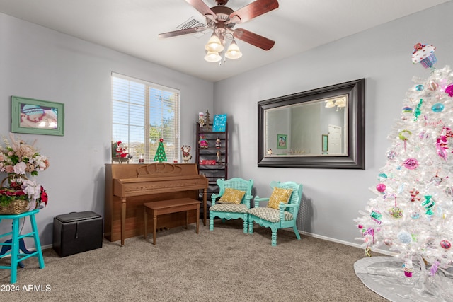 misc room with carpet floors and ceiling fan