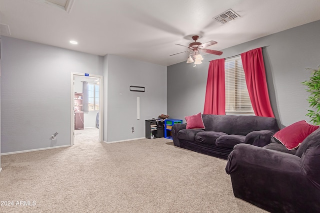 living room featuring carpet flooring and ceiling fan