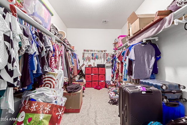 walk in closet featuring carpet flooring