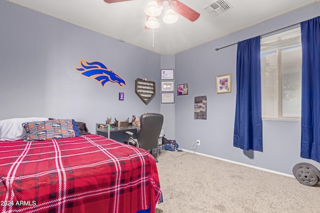 carpeted bedroom with multiple windows and ceiling fan