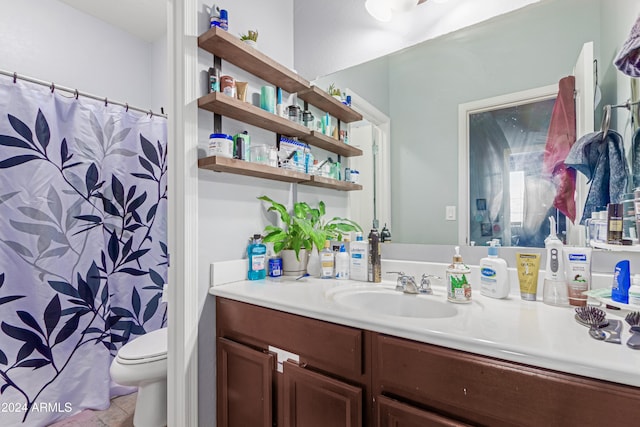 bathroom with tile patterned floors, vanity, and toilet