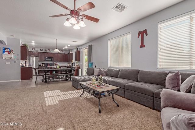 tiled living room featuring ceiling fan