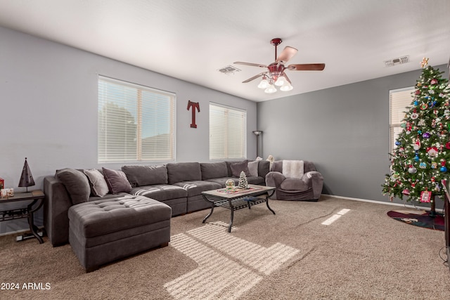 carpeted living room with ceiling fan