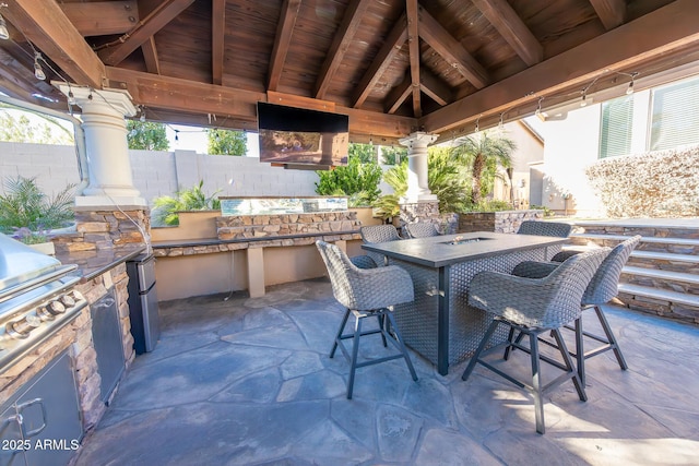 view of patio / terrace featuring an outdoor kitchen and a gazebo