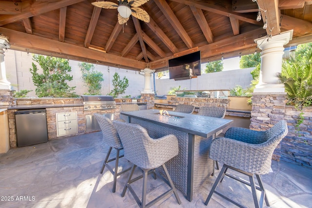 view of patio with an outdoor bar, an outdoor kitchen, a gazebo, a grill, and ceiling fan