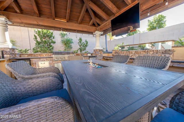 view of patio / terrace featuring a gazebo, an outdoor kitchen, an outdoor bar, and area for grilling