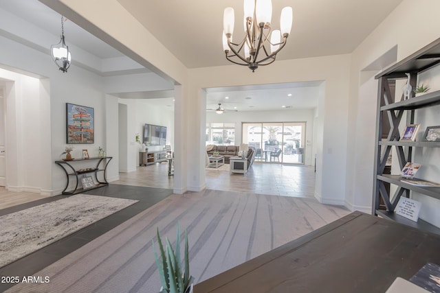 corridor featuring an inviting chandelier and hardwood / wood-style flooring