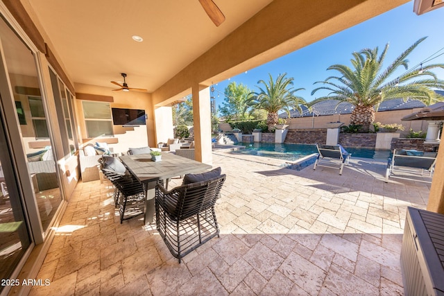 view of patio featuring ceiling fan and pool water feature