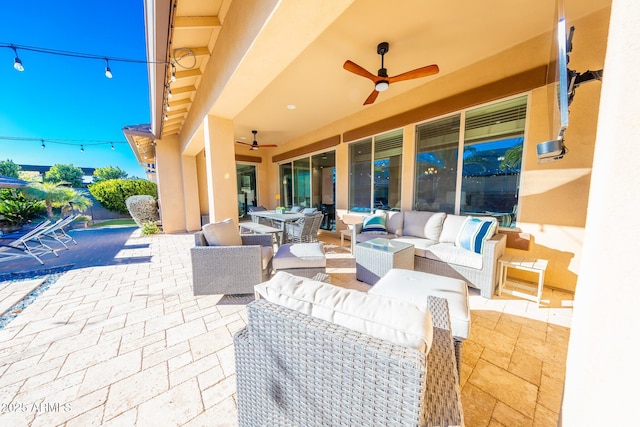 view of patio / terrace with ceiling fan and an outdoor living space