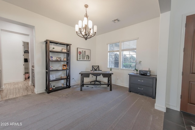 home office with a notable chandelier and carpet flooring